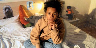 Depressed teenager sitting in bed