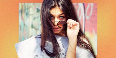 Woman tilting sunglasses with a attitude, needing personal time for self care, reflection