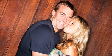 Woman kissing mans cheek, finding a new perspective on marriage