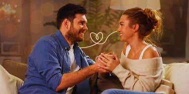 Woman and man feel comfortable doing tiny things in front of each other, while sitting on couch.