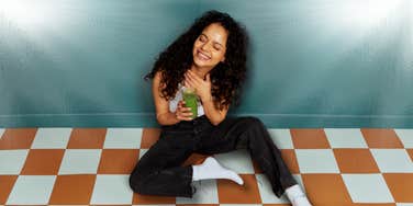 Attractive woman starting her day with a green juice 