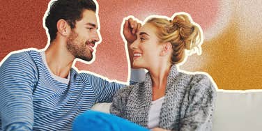 Man craving realness in bed, brushing hair from woman's face