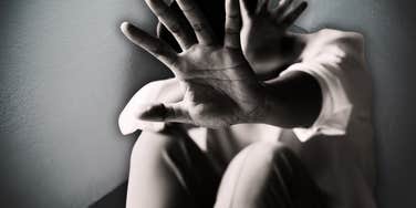 Woman guarding herself from abusive spouse