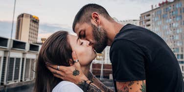Happy couple sharing intimate kiss