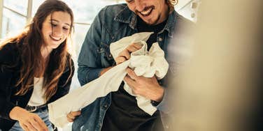 Husband helping wife with laundry 