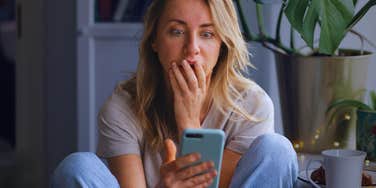 Woman on phone realizes she has subtly been sabotaging her relationship.