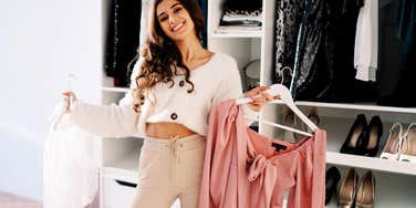 Woman deciding what color to wear on date.