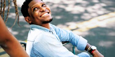 Man in lust and love, looking back smiling at partner
