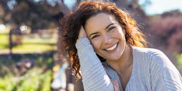 Happy woman outdoors doesn't realize she repels guys 
