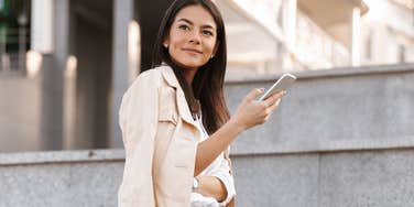 Woman being charming over text, holding phone