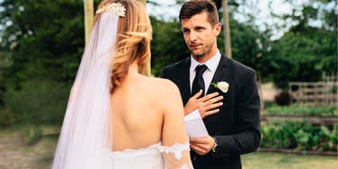 Man saying his heartfelt vows to his wife.