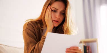 shocked woman reading letter 