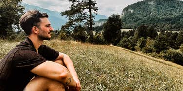 Author sitting in the grass on a beautiful day.