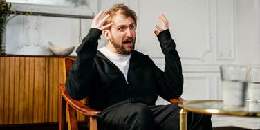 Man sitting in chair having an existential crisis.
