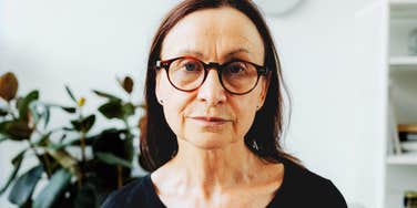 Somber woman reflecting on regrets since ending her twenty eight year marriage. 