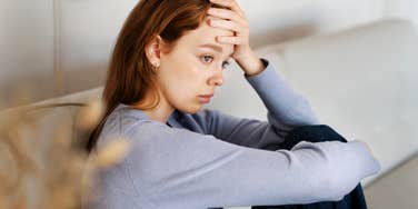 Anxious woman feeling tense in body.
