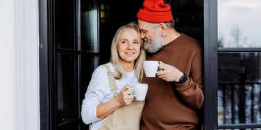 Boomer married couple, happily sharing a cup of tea together 
