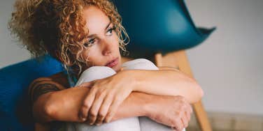 Woman reflecting on marriage while alone.