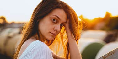 concerned woman holding her head in her hands