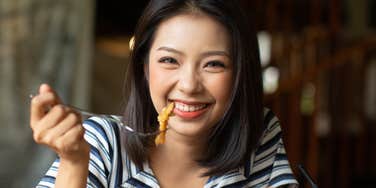 Woman eats food to make her happy.