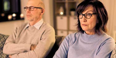 Gen-x man quarreling with his wife at home, feeling stuck in marriage. 