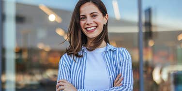 classy woman smiling arms crossed