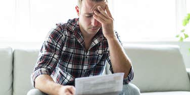 frustrated man looking at bill