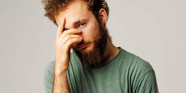Man trying to ignore paralyzing emotion.