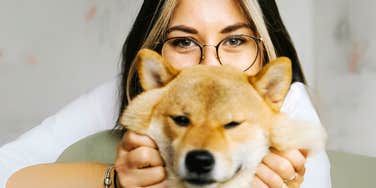 Woman loving on her pet.