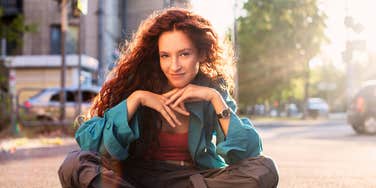 Redheaded teen girl only listening vaguely to her parents talking