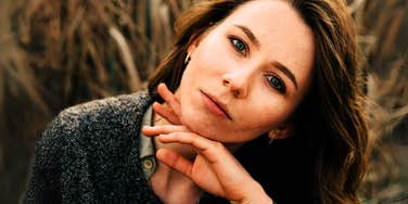 Woman pondering wondering what she needs to be happier.