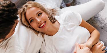 Blonde woman looking lovingly at a man while fixing relationship problem