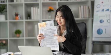 A woman filing her taxes which reveals a lot about her personality