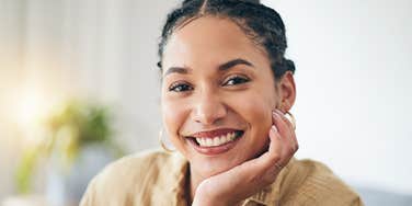 peaceful woman smiling with hand on her chin