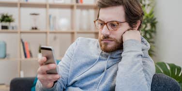 adult child avoiding parents on his phone