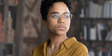 Upset Gen Z worker looking away from the camera. 