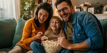 Family laughing at sitcoms featuring nontraditional TV moms