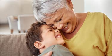 loving grandmother smiling and hugging her grandson