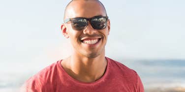 Smiling man in red shirt learns what matters to women 