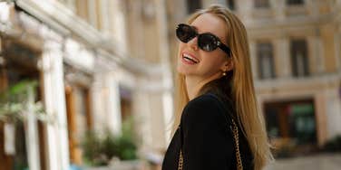 wealthy woman wearing sunglasses outside