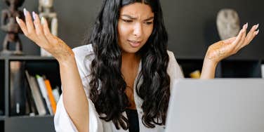 offended worker reading email listing everything wrong with her work history