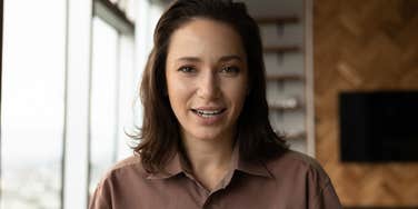 woman in workplace smiling trying not to be rude