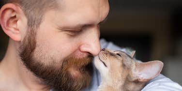 Man whose cat shows cute signs he is happy