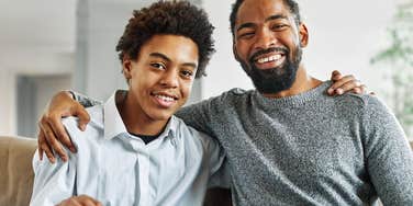 dad and teen son hugging each other