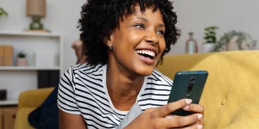 woman using her phone case to attract money