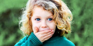 Child not allowed to say these words, covering mouth. 