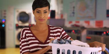 woman doing laundry at the laundromat