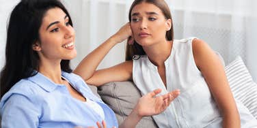 woman uninterested in conversation but pretending she cares
