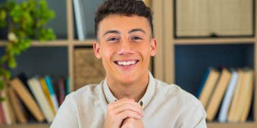smiling young man being a pushover not standing up for himself