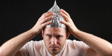 conspiracy theorist in tinfoil hat